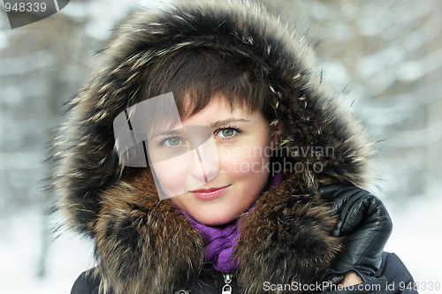 Image of Cute woman in frosty day hands at hood