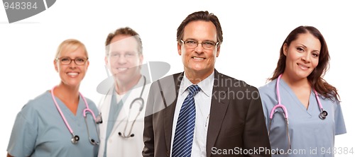 Image of Smiling Businessman with Male and Female Doctors and Nurses