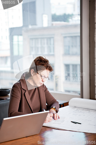 Image of Businesswoman writing on a paper