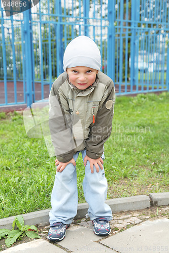 Image of Little boy bending forward