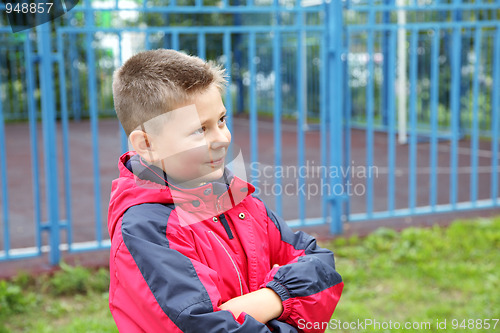 Image of Boy outdoors arms folded