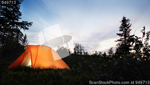 Image of A tent lit up at dusk 