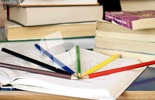 Image of Colored pencils on the book. 