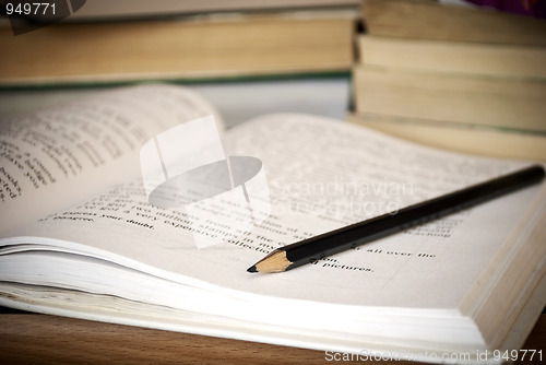 Image of Black pencil on the book.