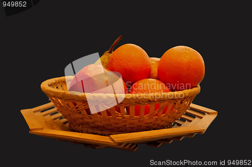 Image of The isolated basket with oranges, an apple and a pear