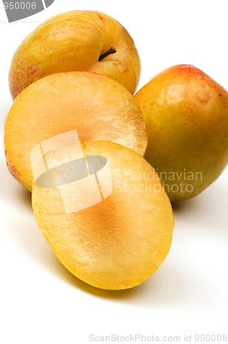 Image of yellow green sweetie and red pluot fruits