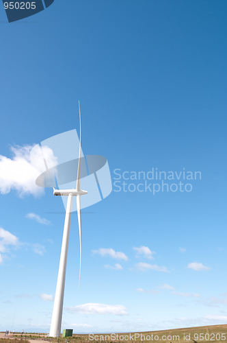 Image of Single wind turbine against blue sky