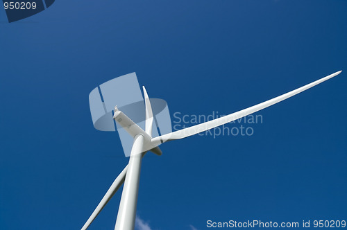 Image of Wind turbine close up in deep blue sky