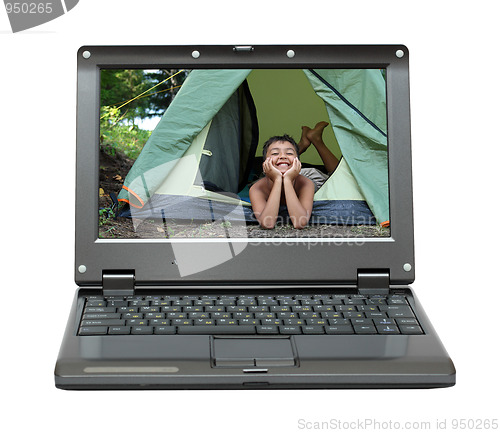 Image of laptop with happy boy in camping tent