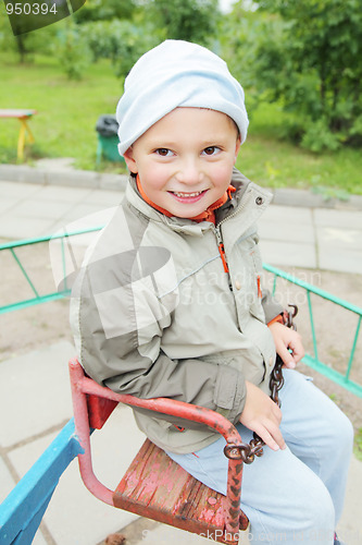 Image of Little boy on rolling swing