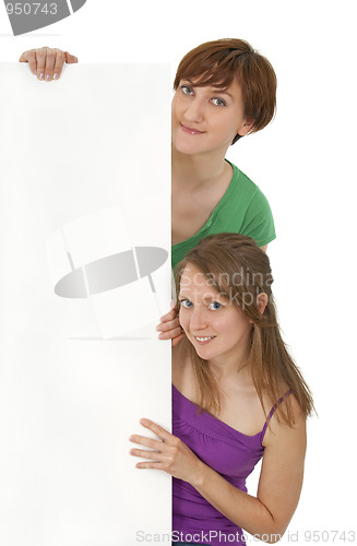 Image of Two friendly young women holding a blank banner ad