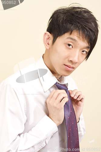 Image of Young Asian man wearing suit