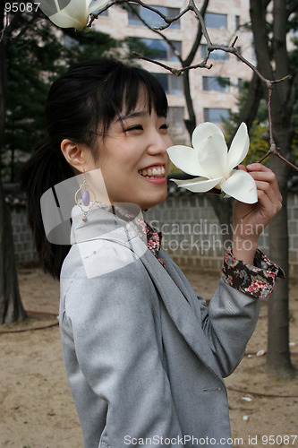 Image of Pretty Korean woman holding a flower