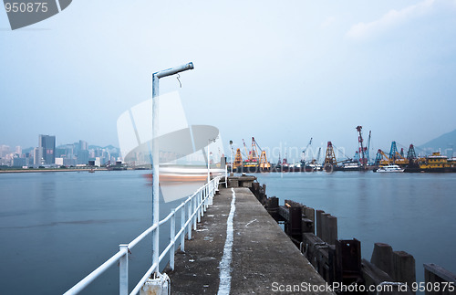 Image of Deserted jetty at a foggy sea near a dutch city. 