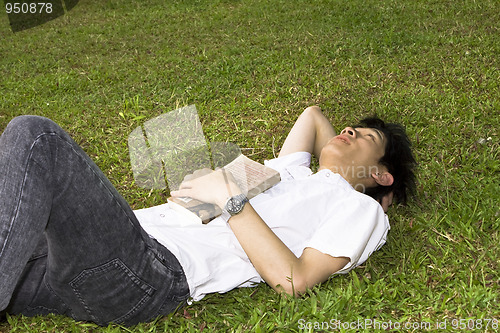 Image of asia man relax on the grass