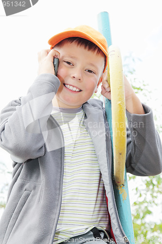 Image of Boy sitting on staircase with cellphone