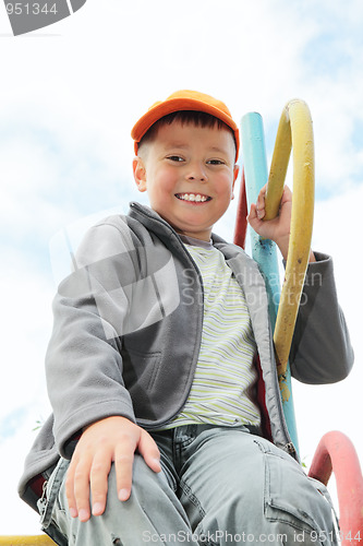 Image of Boy sitting on climbing staircase