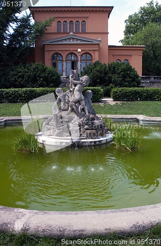 Image of Small fountain with sculptures of boys in garden