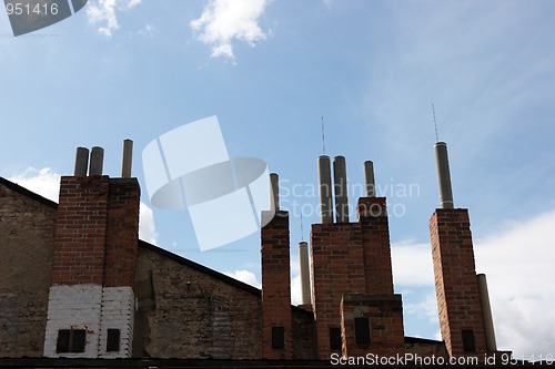 Image of Many of brick chimneys on the top of the house