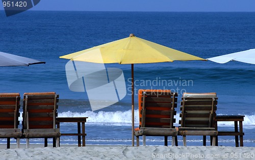 Image of colorful beach umbrellas with seats