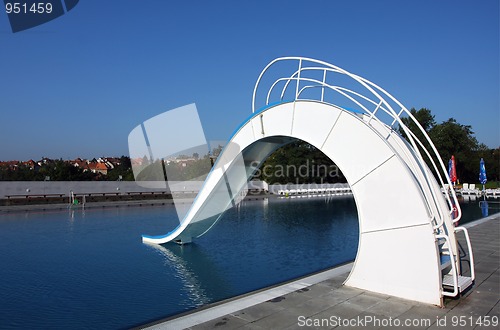 Image of dispeopled bath pool with white slide