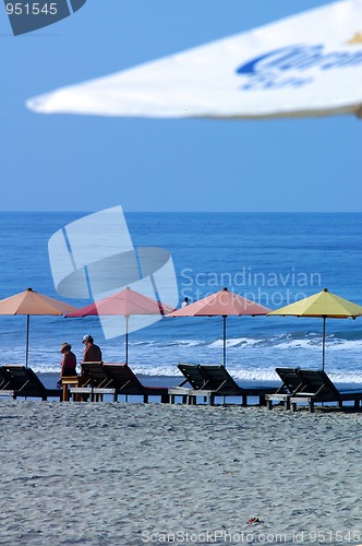 Image of colorful beach umbrellas with seats