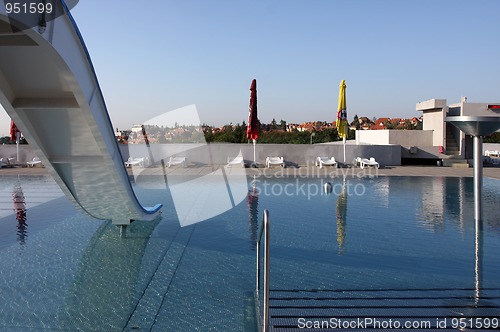 Image of dispeopled bath pool with white slide