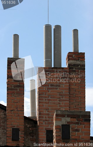 Image of Many of brick chimneys on the top of the house