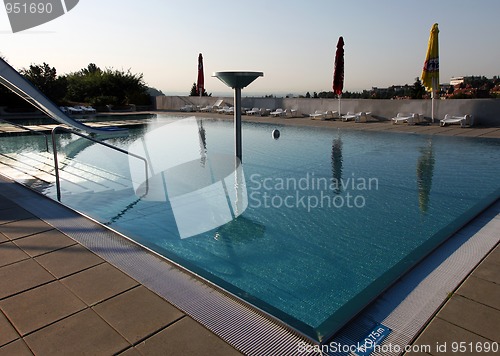 Image of dispeopled bath pool with white slide