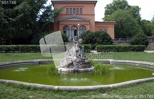 Image of Small fountain with sculptures of boys in garden