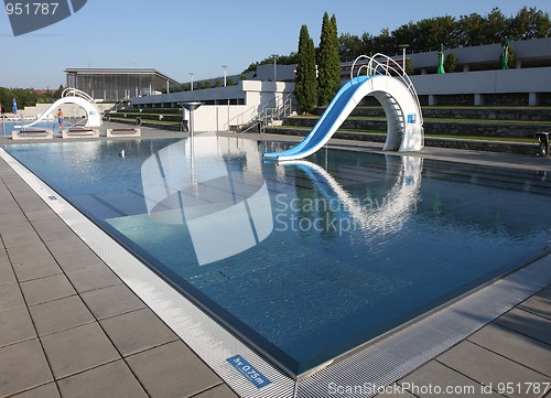 Image of dispeopled bath pool with white slide