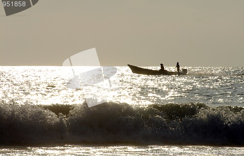 Image of Silhouette of two men on boat during sunset