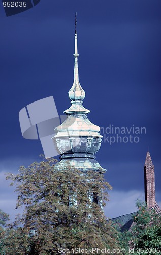 Image of Tower of church on the blue cloudy sky