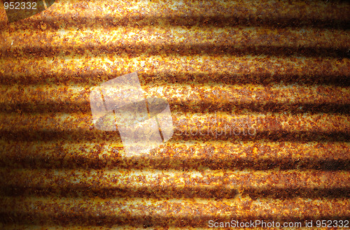 Image of Rusty corrugated metal can surface lit diagonally