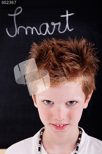 Image of Cute and smart kid, in front of blackboard