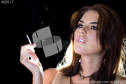 Image of young sexy brunette with cigarette