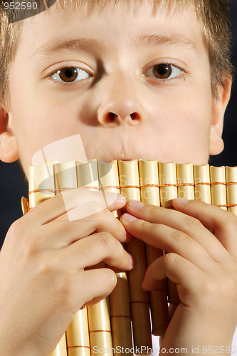 Image of Boy playing panflute