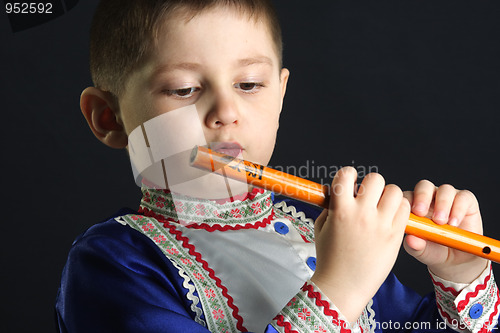 Image of Little kid looking at wooden flute