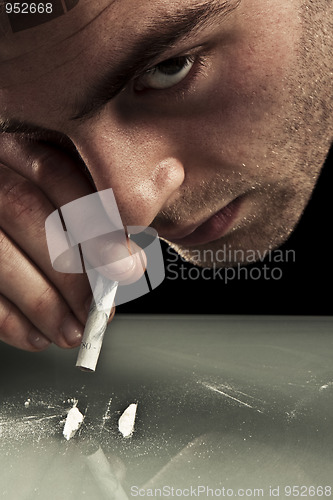 Image of Young man sniffing cocaine.