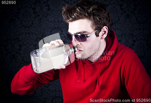 Image of young man drinking and feeling despair