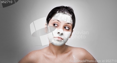 Image of Cosmetician make mask to girl. Facial massage.