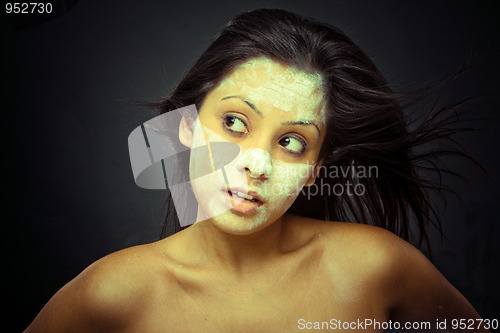 Image of Cosmetician make mask to girl. Facial massage.