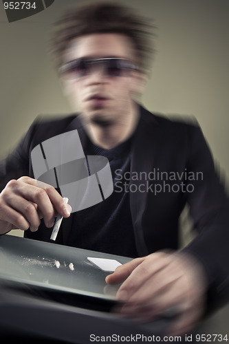 Image of Young man sniffing cocaine.