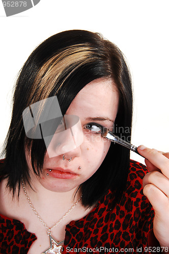 Image of Girl doing makeup.