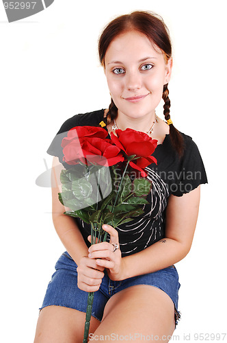 Image of Pretty girl sitting on a chair with roses.