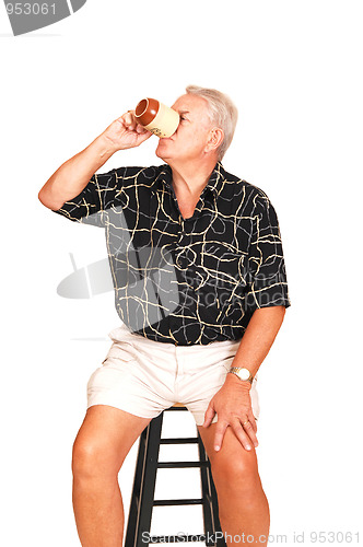 Image of Senior on a bar chair.