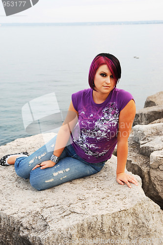 Image of Girl sitting on lakeshore.