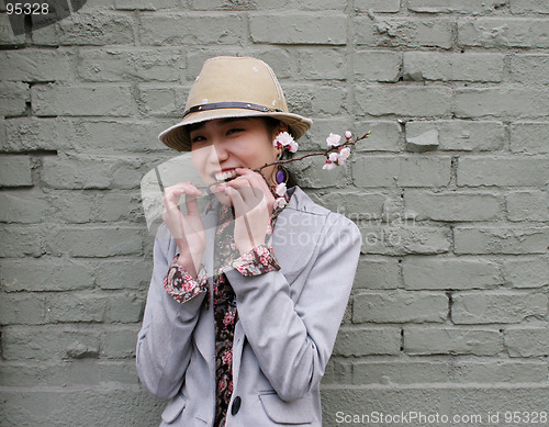Image of Woman with a flower in her mouth