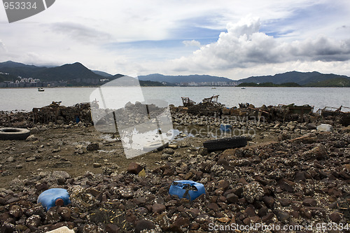 Image of Garbage piled up on the coast of the ocean. 