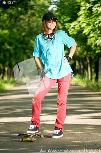 Image of Teenage girl with skateboard